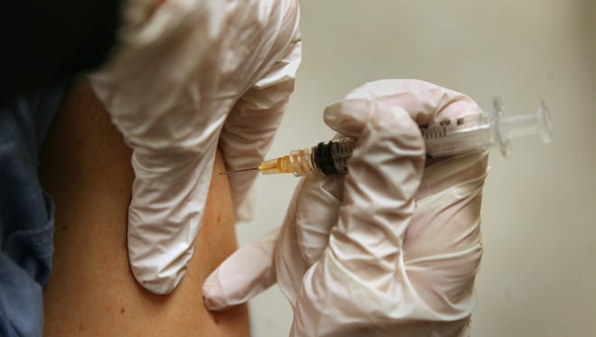 A flu shot being administered.
