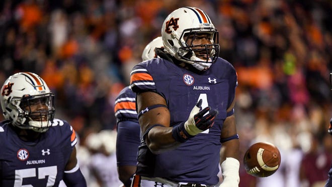 Auburn defensive tackle Montravius Adams celebrates after picking up a deflected pass on Nov 19, 2016.