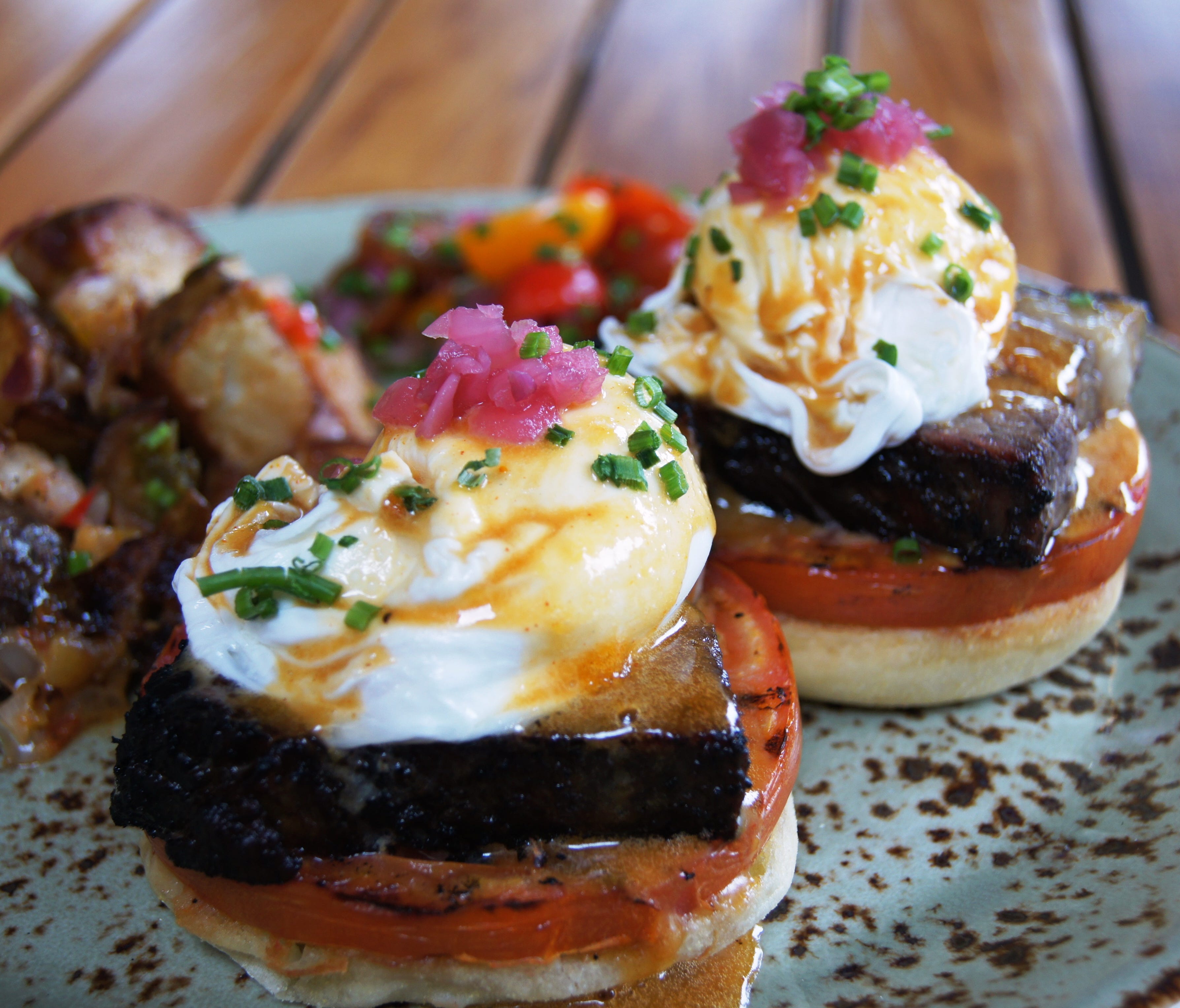 Highball & Harvest at The Ritz-Carlton Orlando, Grande Lakes, offers a Smoked Brisket Benedict. The brisket is rubbed with local Lineage Coffee Roasting coffee and served alongside griddled tomato, poached egg, and Surplus barbecue hollandaise.