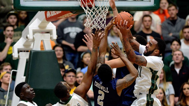 Colorado State forward Stanton Kidd (11) pulls in a rebound over Wolf Pack guard Tyron Criswell on Wednesday.