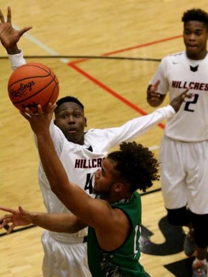 Easley's Elijah McKinney (12) shoots over Hillcrest's Jaquan Holmes (42) in the first quarter of their first round Class AAAAA playoff game at Hillcrest High School on Wednesday night, February 15, 2017.