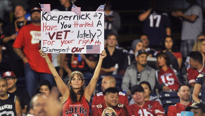 A San Francisco 49ers fan holds up a sign in reference to quarterback Colin Kaepernick (not pictured) during the second half of the game against the San Diego Chargers at Qualcomm Stadium. San Francisco won 31-21.