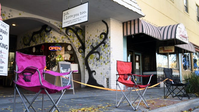 Chairs block the walkway in front of P.S. I Love You Too in downtown Visalia on November 27, 2017. Residents positioned chairs along Main Street in anticipation for the 72nd Candy Cane Lane Parade.