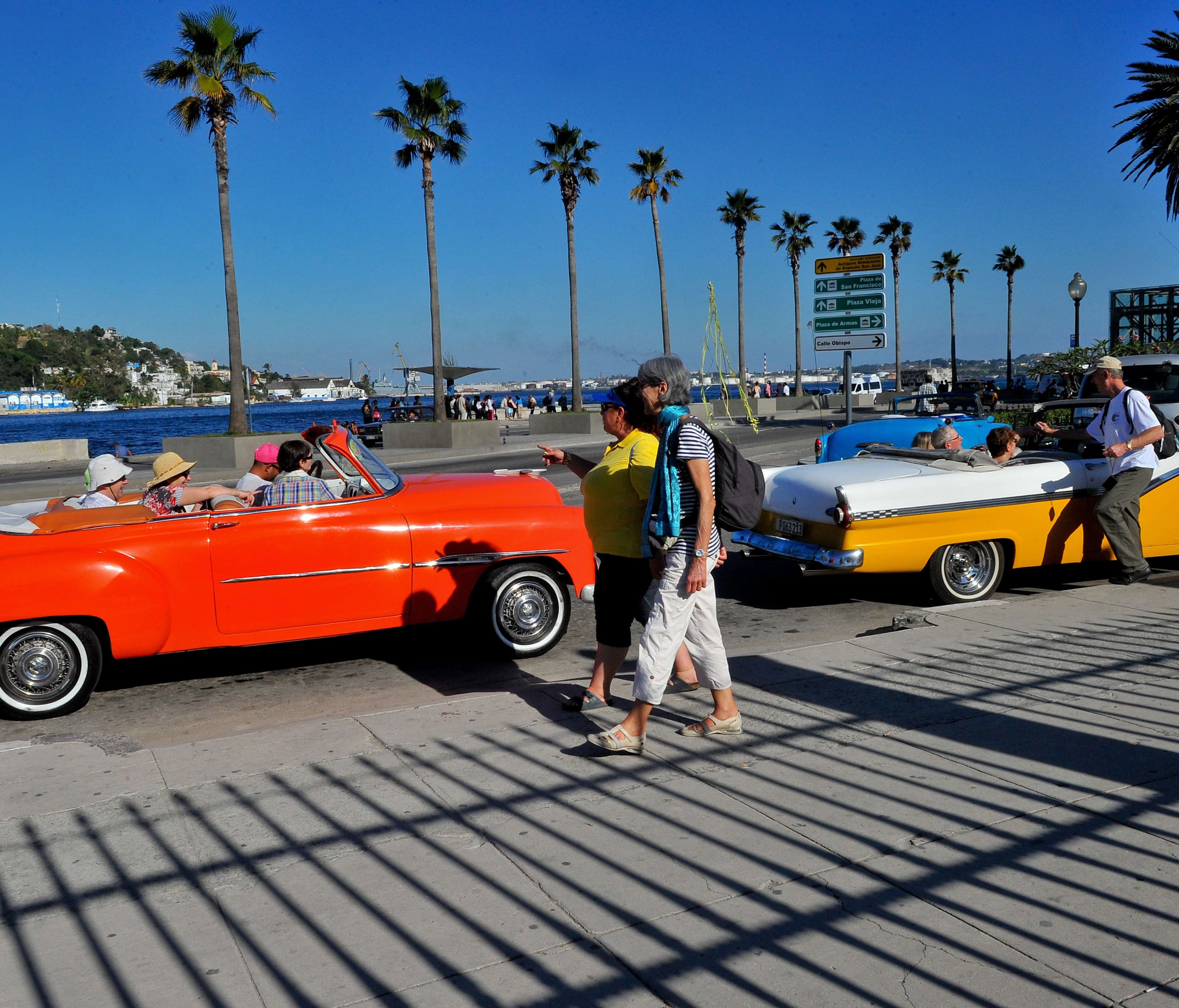 Tourists from the United States are seen in old American cars in Havana, on April 6, 2015.