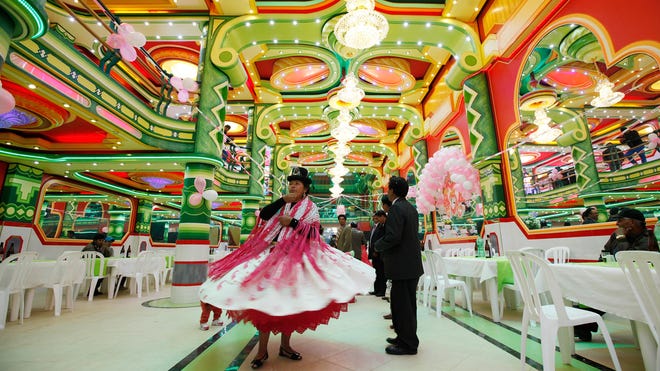 An Aymara woman dances in a ballroom of one of the newfangled mini-mansions rising up in El Alto, Bolivia.