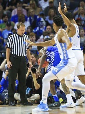Referee John Higgins watches the play of Kentucky and North Carolina during the Elite Eight game at Memphis. The Tarheels beat the Wildcats 75-73, but some UK fans threatened the NCAA official via social media after the loss.