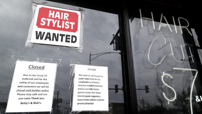 FILE - In this April 30 ,2020 file photo, a barber shop shows closed and hiring sign during the COVID-19 in Chicago. On Thursday, Aug. 27, just over 1 million Americans applied for unemployment benefits last week, a sign that the coronavirus outbreak continues to threaten jobs even as the housing market, auto sales and other segments of the economy rebound from a springtime collapse. (AP Photo/Nam Y. Huh, File)