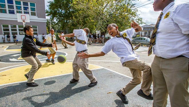 Students play basketball during recess at John Dibert Community School, a New Orleans charter.