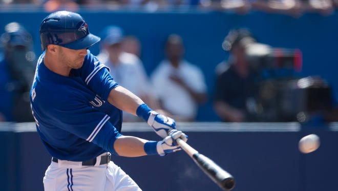 Toronto Blue Jays' Nolan Reimold hits the game-winning RBI double in the tenth inning of a baseball game, Saturday, Aug. 9, 2014 in Toronto. The Blue Jays defeated the Tigers 3-2.