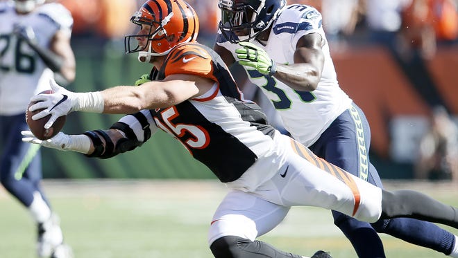 Cincinnati Bengals tight end Tyler Eifert (85) dives to catch a pass in the fourth quarter during the NFL game between the Seattle Seahawks and the Cincinnati Bengals, Sunday, Oct. 11, 2015, at Paul Brown Stadium in Cincinnati, Ohio. The Bengals defeated the Seahawks 27-24 in overtime.