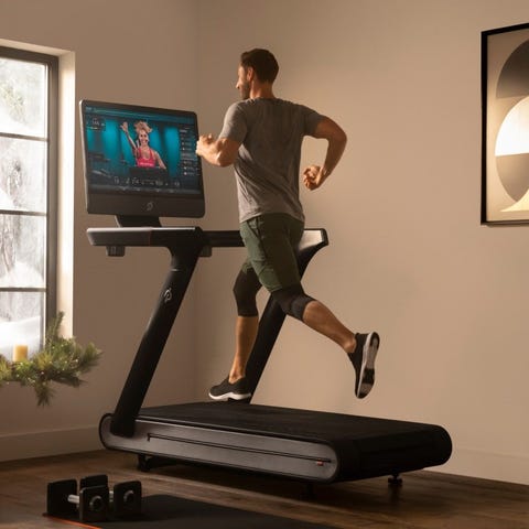 Man running on a Peloton connected treadmill.