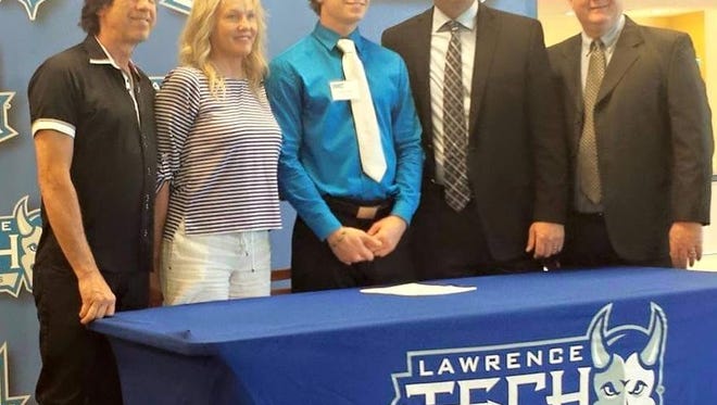 Dylan Smith is pictured with his parents Michael and Tama and members of the Lawrence Tech coaching staff.
