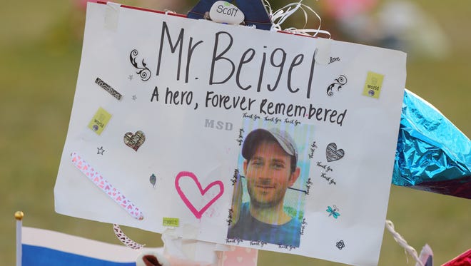 A memorial for Geography teacher and cross-country coach, Scott Beigel is shown on Tuesday Feb. 20, 2018 at Pine Trails Park in Parkland, Fla.