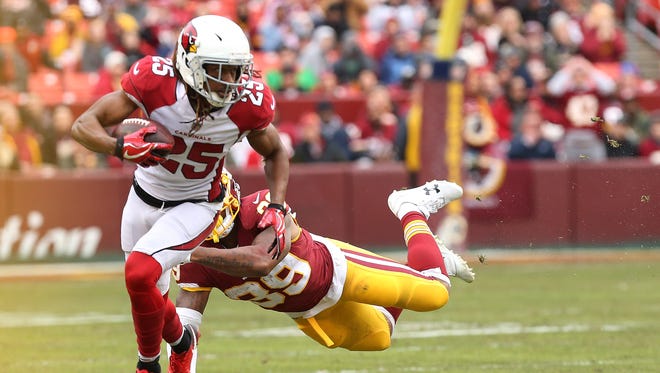 Arizona Cardinals defensive back Tramon Williams (25) returns a fumble as Washington Redskins running back Kapri Bibbs (39) attempts the tackle in the second quarter at FedEx Field.