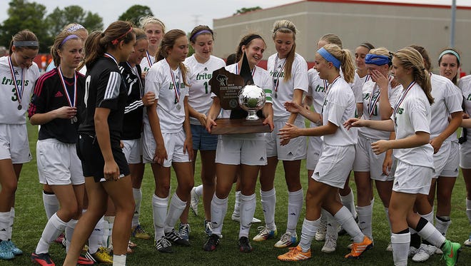 Green Bay Notre Dame's Madi Larsen (20) holds the runner-up trophy after Saturday's Division 3 championship game in the WIAA state girls soccer tournament at Uihlein Soccer Park in Milwaukee.