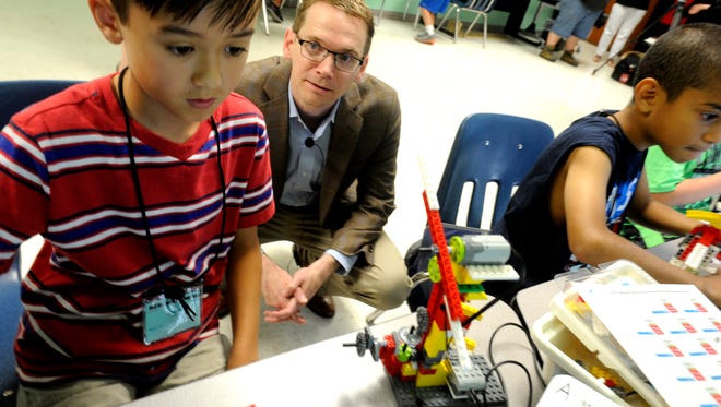 Texas Commissioner of Education Mike Morath talks to Cayden Bauer, 9, while he designs a wind turbine during the Abilene ISD Summer Technology Camp on Tuesday, June 6, 2017, at the ATEMS campus. 