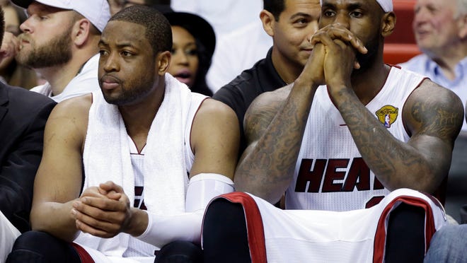 
Miami Heat forward LeBron James (right) and guard Dwyane Wade sit on the bench during the last minutes of the second half in Game 4 of the NBA Finals against the San Antonio Spurs on Thursday.
