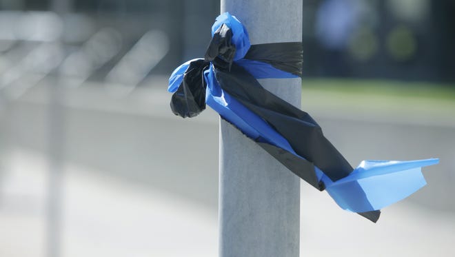 Black and blue ribbons were tied in preparation for the funeral service for officer Daryl R. Pierson ithis week.
