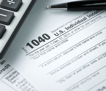 1040 form with calculator and pen