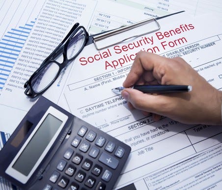 A person filling out a Social Security benefits application form.