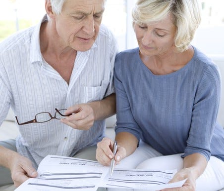 Senior couple reviewing paperwork