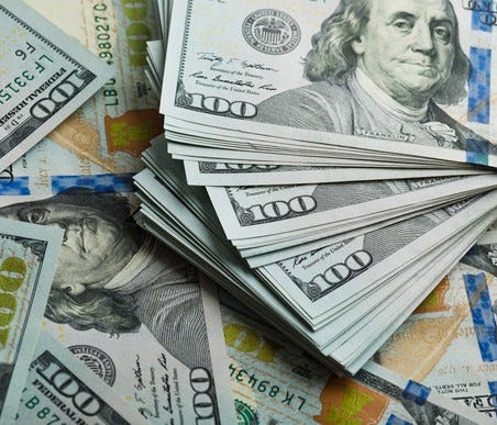 Large pile of hundred dollar bills