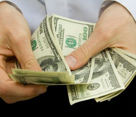Man counting 100-dollar bills
