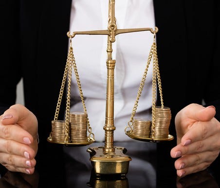 A scale roughly balanced with coins on both sides.