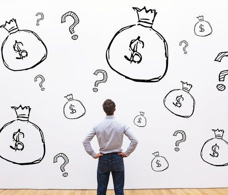 Man looking at wall with drawings of money bags and question marks