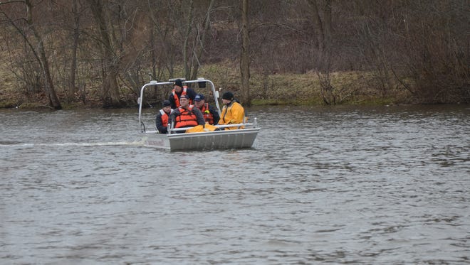 Searchers looking Tuesday for the missing car in the Kalamazoo River west of 20th Street.