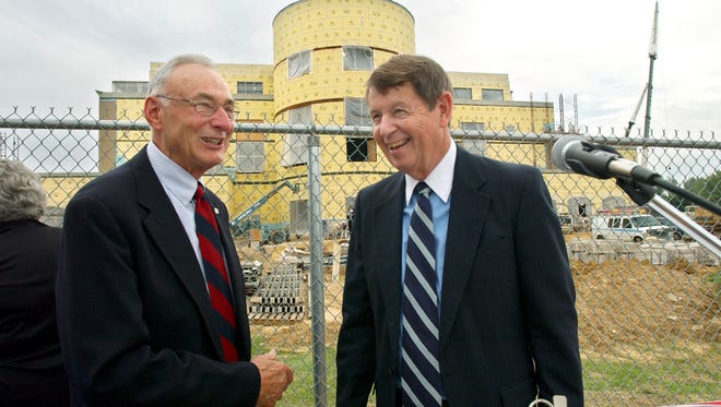 Former USI president David L. Rice, left, jokes with then president H. Ray Hoops (cq) during a cornerstone placement ceremony on the USI campus in conjunction with the university's 40th birthday. The cornerstone, which contained a time capsule, was placed at the construction site of the David L. Rice Library, background.