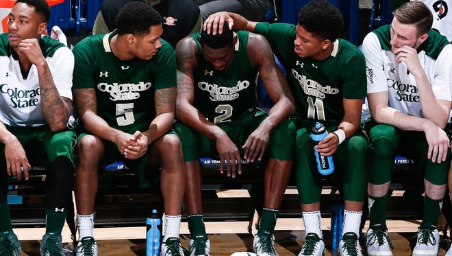CSU forward Emmanuel Omogbo (middle) is consoled by teammates guard Prentiss Nixon (11) and guard Fred Richardson III (5) in the second half against the Air Force Falcons at Clune Arena.