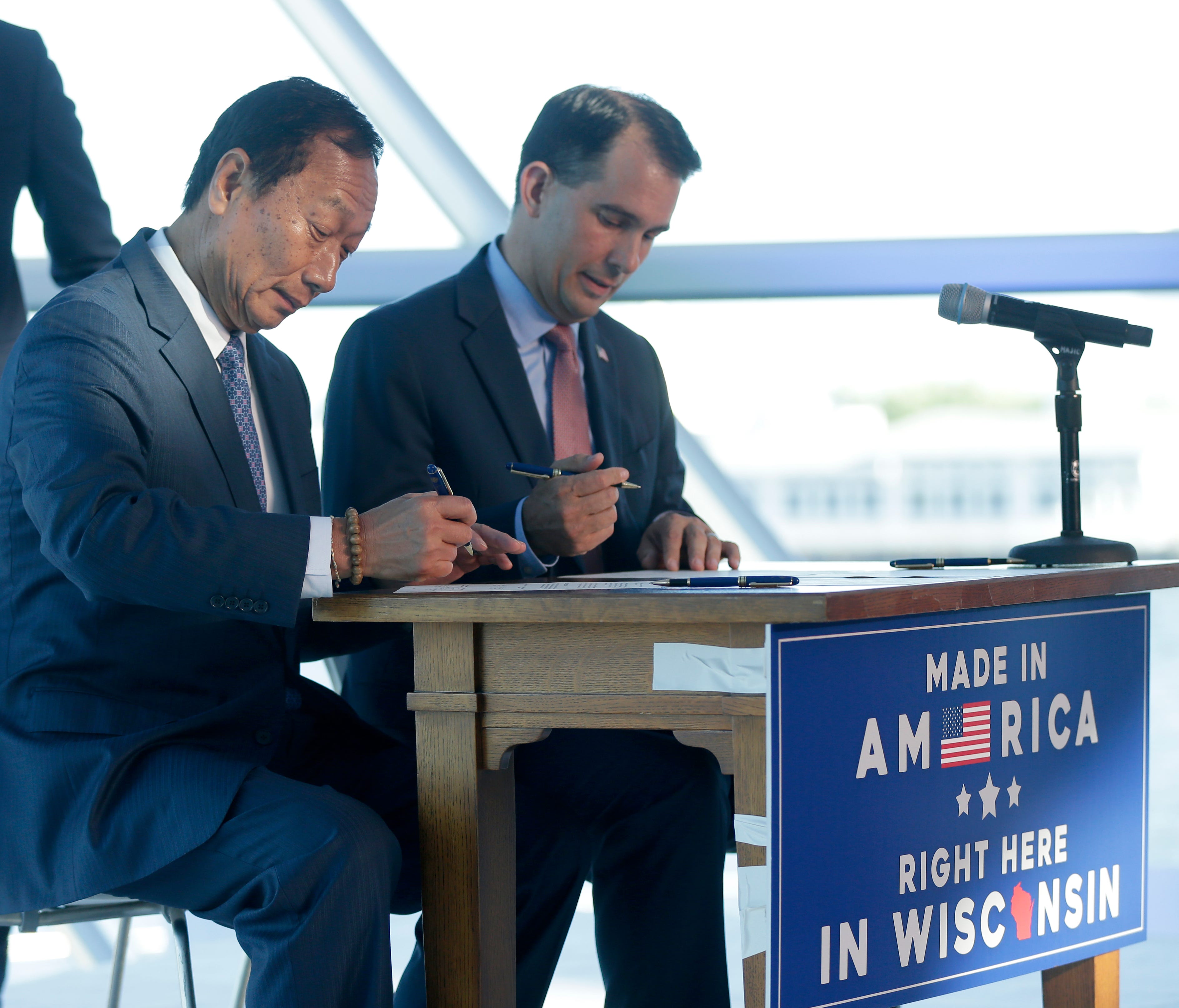 Foxconn Chairman Terry Gou (left) and Gov. Scott Walker sign a memorandum of understanding regarding Foxconn's plan to build a $10 billion factory in Wisconsin.