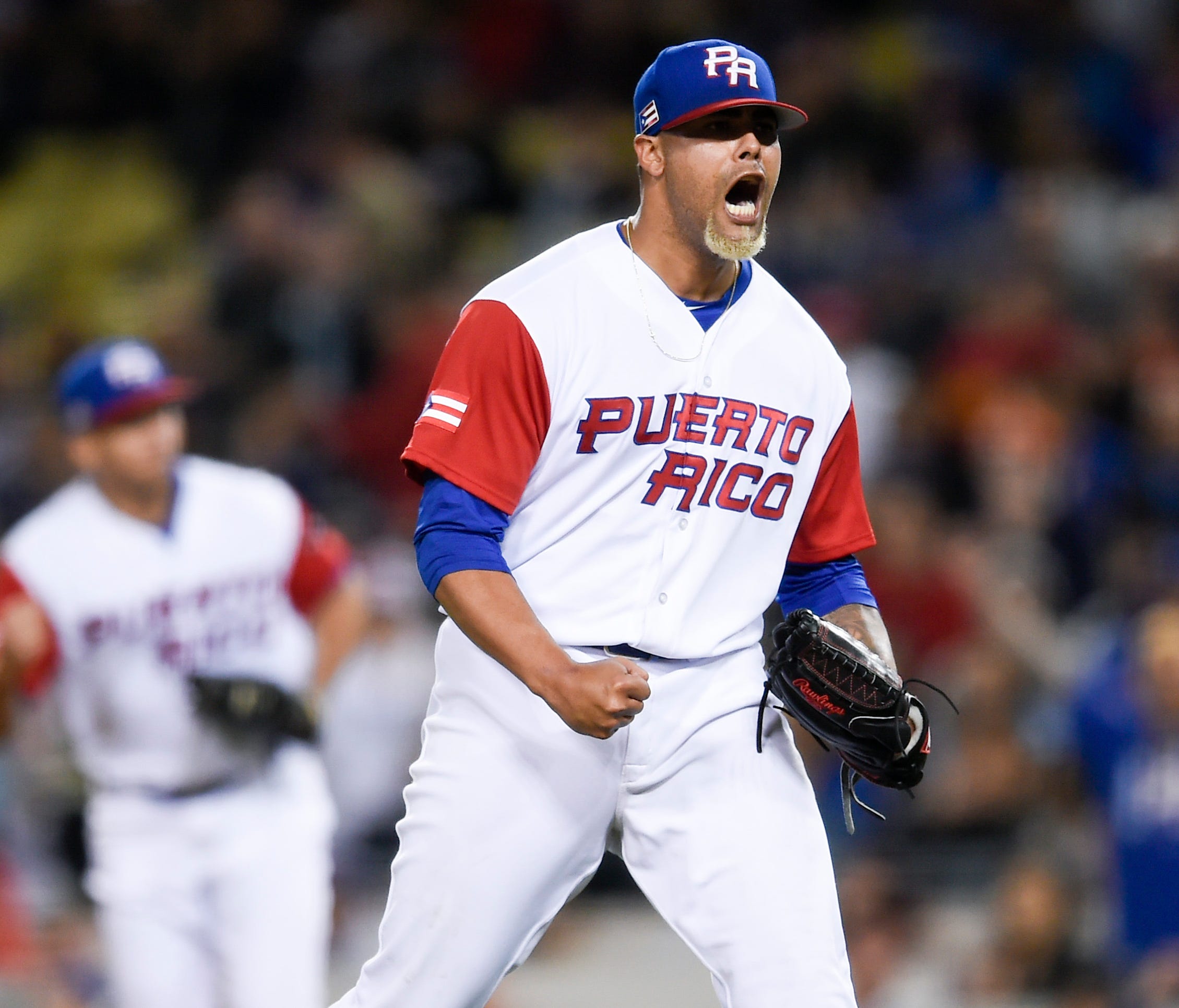Joseph Colon exults after inducing an eighth-inning double play, part of a clutch relief effort from the Puerto Rico bullpen.