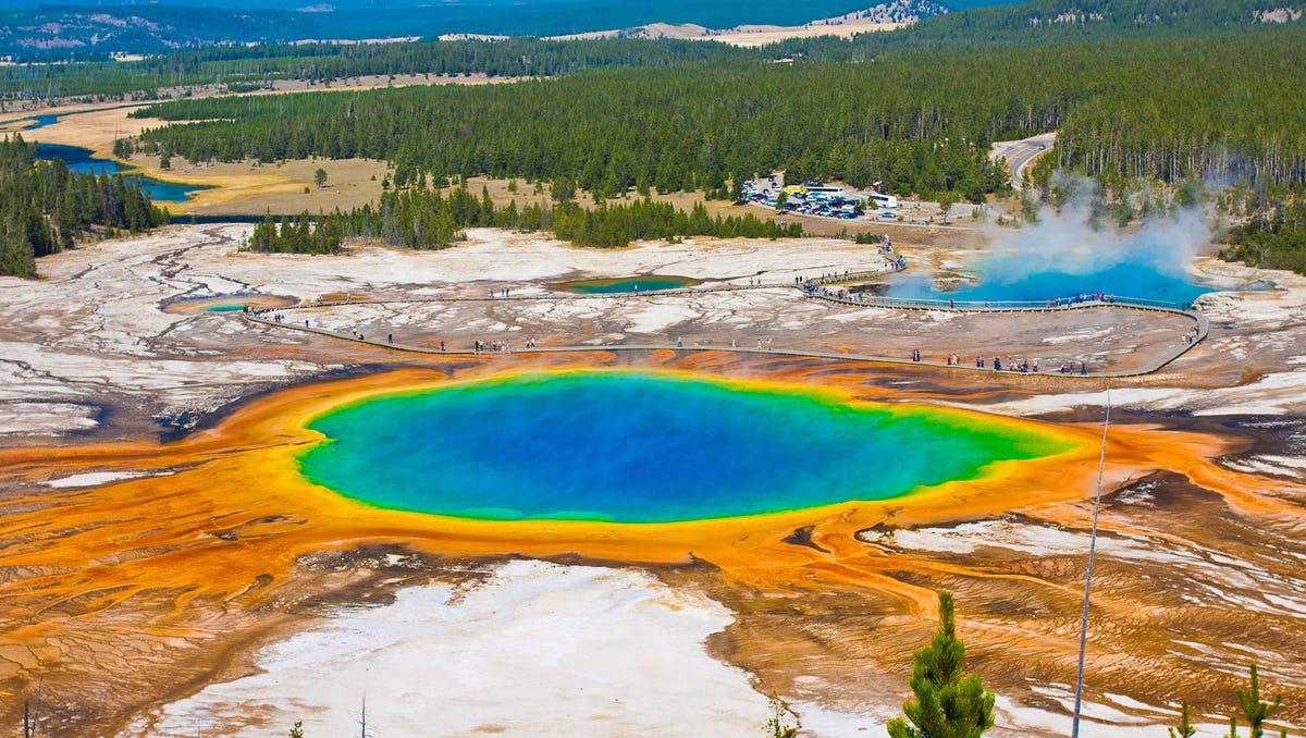 Wyoming: Yellowstone National Park is a natural bucket list destination when you visit Wyoming, and there are places in the park you won't want to miss. Old Faithful Geyser will be on your itinerary, but you'll want to see Grand Prismatic Spring, too. The geyser has a bright blue center with rings of color in reds and green circling outward. The show is due to a combination of pigmented heat-loving bacteria   and light reflection. It's also the third largest geyser in the world: It's wider than a football field and is deep enough to swallow a 10-story building. Take a trip up to Isa Lake while you're there. Perched astride the Continental Divide, the mountain lake drains into both the Gulf of Mexico and the Pacific Ocean.