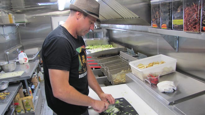 Taco Reho chef and owner Billy Lucas prepares for a night of service in his food truck.