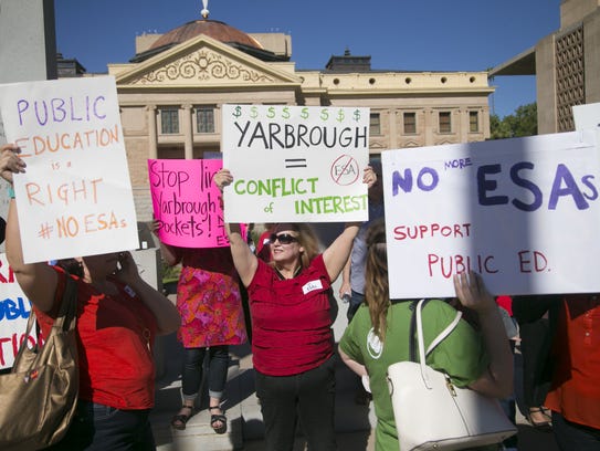 Protesters rally against an expanded school voucher