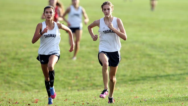 This is the third season that Ellie Songer, left, and Claire Ashton have been a part of the Webster Thomas Titans girls cross country team's top four runners.