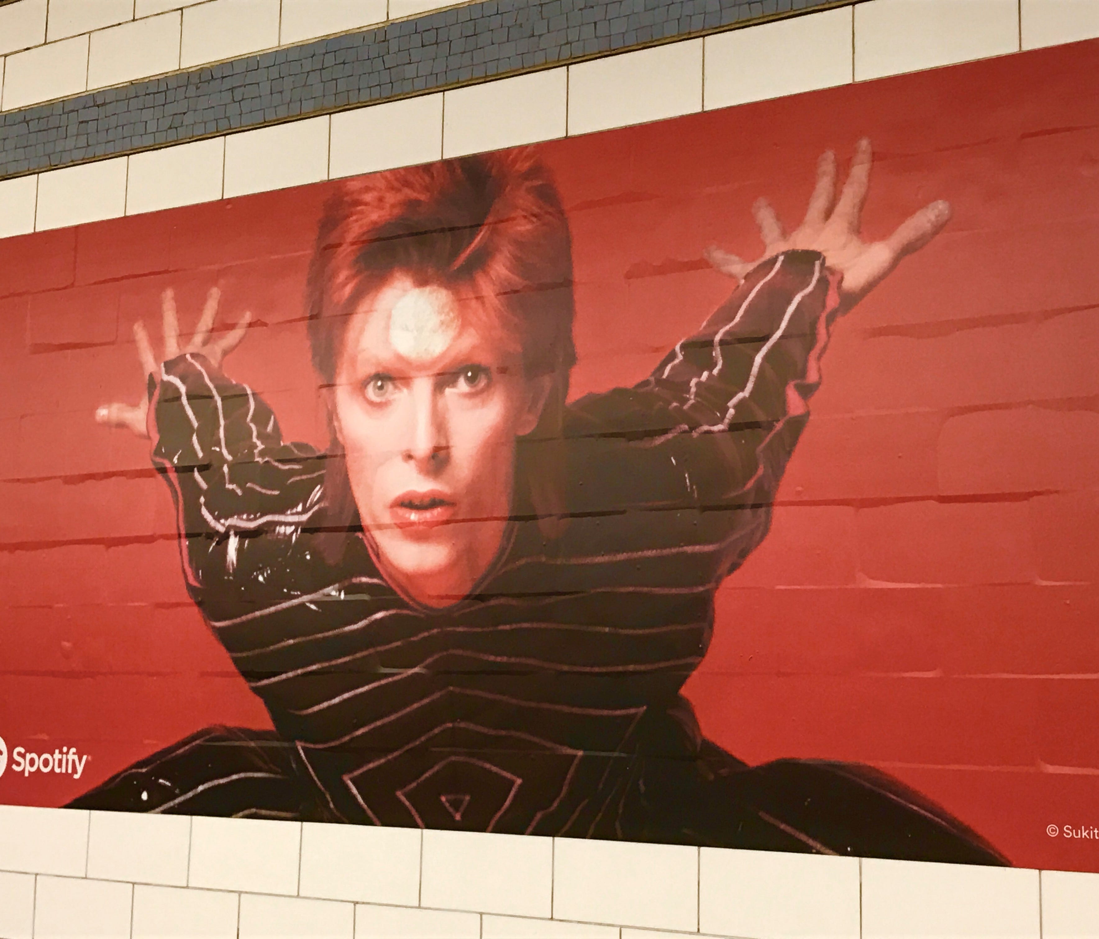 These David Bowie photos are displayed on the platform of the Bleecker Street station.