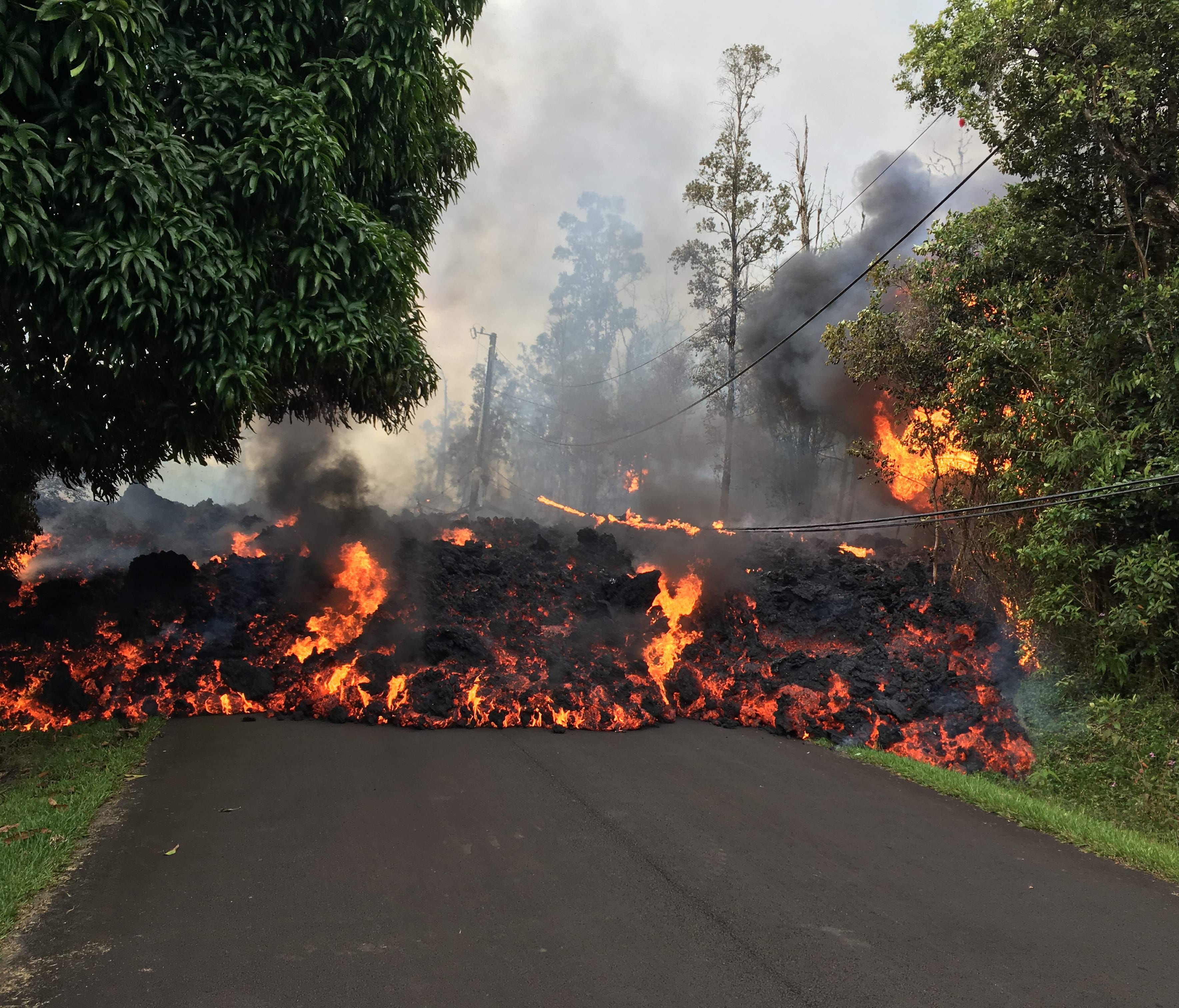 This image obtained May 9, 2018, released by the US Geological Survey shows a lava flow moving on Makamae Street in Leilani Estates at 09:32 am local time, on May 6, 2018 in Leilani Estates, Hawaii.The Kilauea Volcano, the most active in Hawaii, was 
