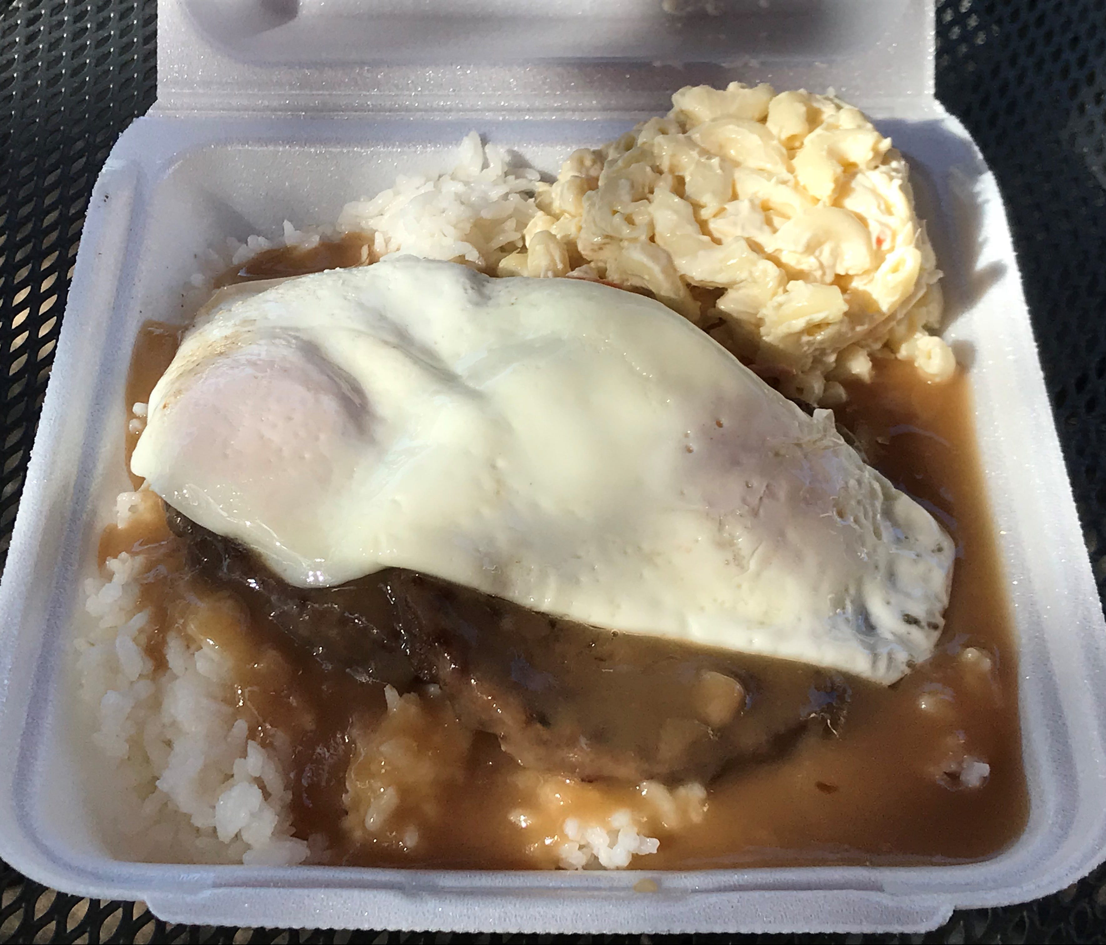 A classic Hawaiian breakfast specialty offered as an all-day plate lunch option is Loco Moco, two hamburger patties topped with brown gravy and fried eggs.