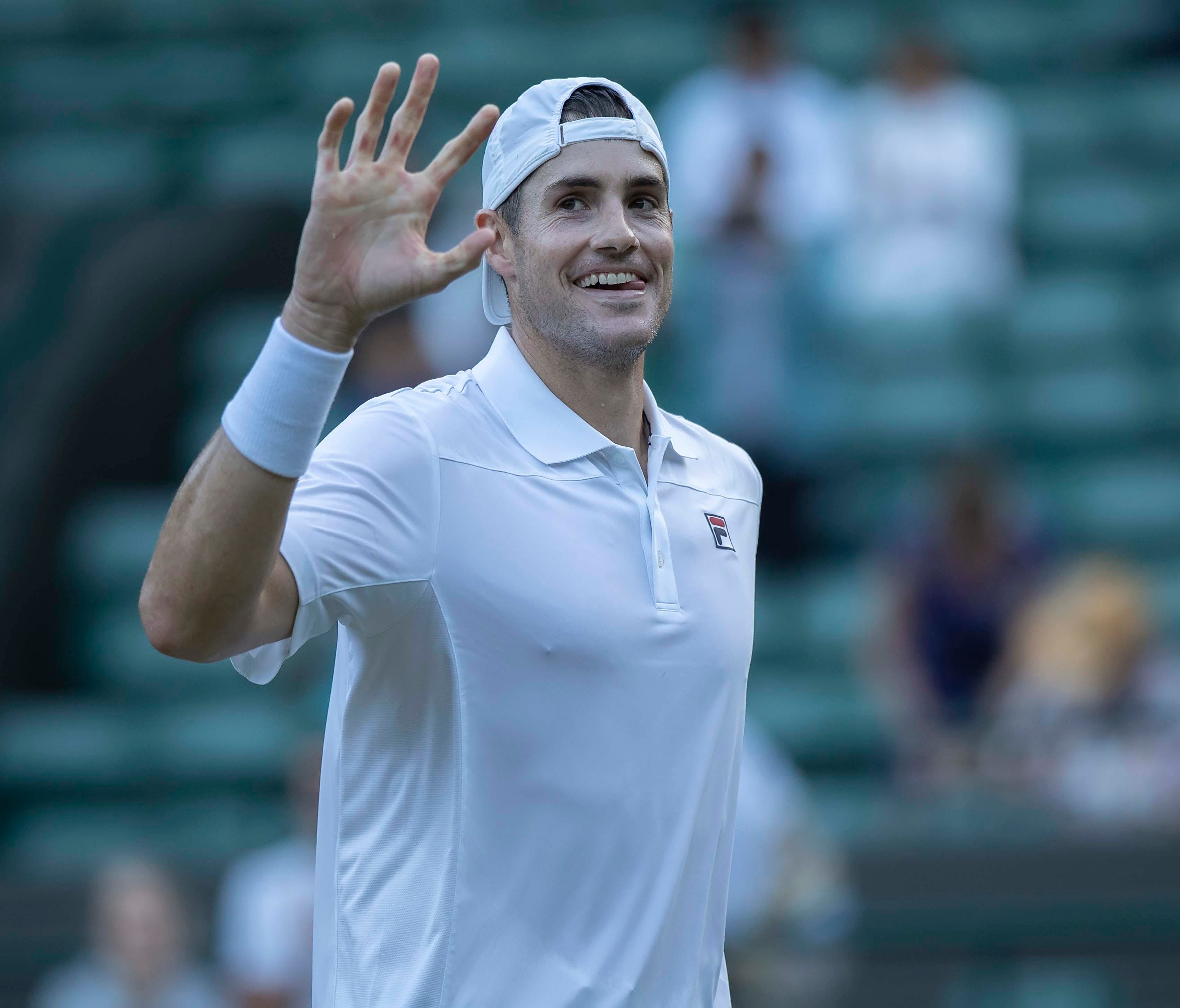 John Isner celebrates match point during his match against Milos Raonic on day nine of Wimbledon at All England Lawn and Croquet Club on July 11.