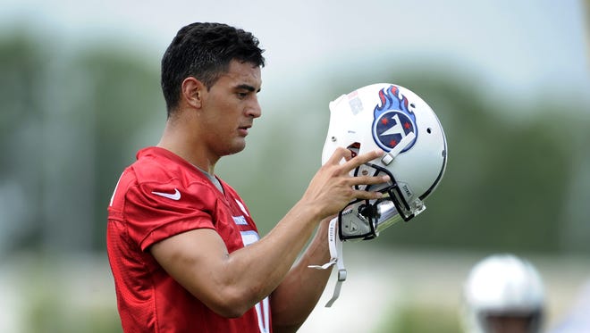 Titans quarterback Marcus Mariota (8) puts on his helmet during a practice at rookie mini-camp at St. Thomas Sports Park, May 15, 2015, in Nashville, Tenn.
