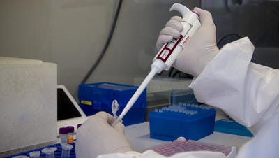Public health scientist Jessica Escobar prepares samples for measles virus testing on May 31 at the Arizona Public Health Laboratory in Phoenix.