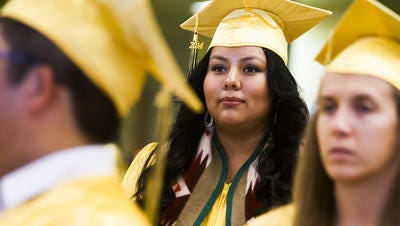 Desiree Flores, center, participates in Scottsdale Community College’s Hoop of Learning, an academic program for Native American students, while also attending Coronado High School. Here, she waits to receive her associate's degree from Scottsdale Community College on May 9, 2014.