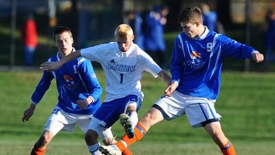 Livonia defenders surround a Mattituck player during the Class B state semifinals in 2012. The Bulldogs went on to share the title with Ichabod Crane.