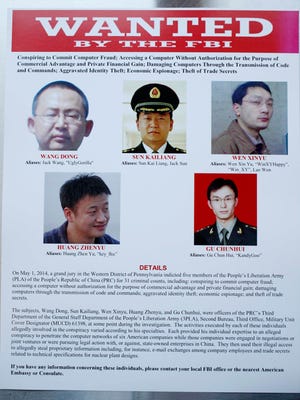 This wanted poster is displayed at the Justice Department in Washington. Cyber crimes allegedly committed by Chinese hackers have put American's digital records at risk.