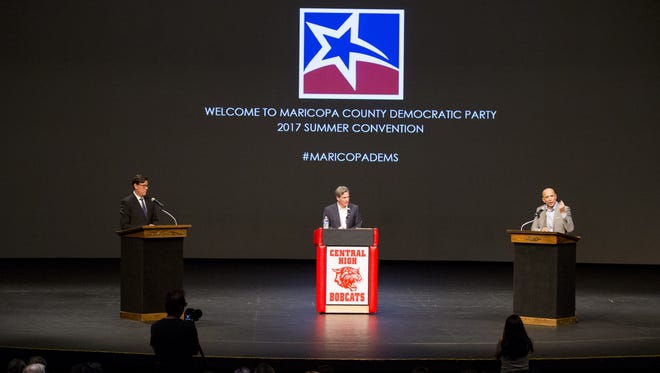 Democratic governor candidates state Sen. Steve Farley (left) and David Garcia (right), an education-leadership professor, speak during a forum at the Maricopa County Democratic Party summer convention at Central High School in Phoenix on Aug. 19, 2017. Brahm Resnik of 12News served as moderator.