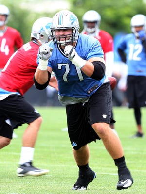 Detroit Lions takcle Riley Reiff goes through drills during training camp July 29, 2013, in Allen Park.