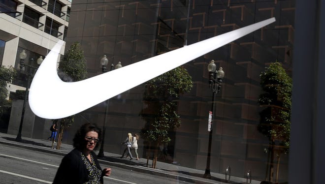 File image shows The Nike logo displayed in a window at a Nike Store on September 26, 2017, in San Francisco, California.